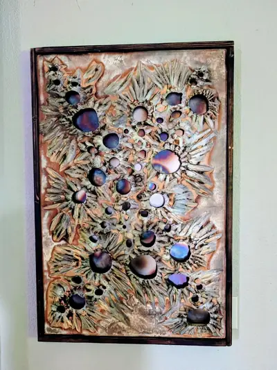 Framed wall panel with carved texture and iridescent purple and blue resin discs set into the surface
