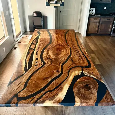 Wide live edge walnut dining table with black epoxy filling the natural voids and cracks